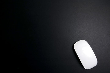 White mouse over a black background.
