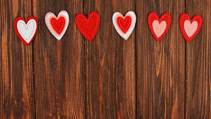 beautiful red heart ornaments on a wooden background on lovers, on Valentine's Day, feast of love in February