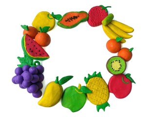 Colorful plasticine clay made are variety of fruit arranged as a frame on white background