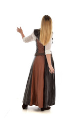 Fototapeta premium full length portrait of girl wearing brown fantasy costume, standing pose with back to the camera on white studio background. 
