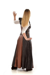 Fototapeta premium full length portrait of girl wearing brown fantasy costume, standing pose with back to the camera on white studio background. 