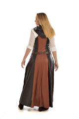 Fototapeta premium full length portrait of girl wearing brown fantasy costume, standing pose with back to the camera on white studio background. 