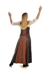 Fototapeta premium full length portrait of girl wearing brown fantasy costume, standing pose with back to the camera on white studio background. 