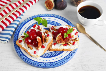Delicious toasts with fruits on plate