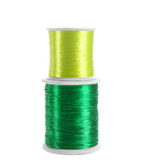 Green sewing threads on white background