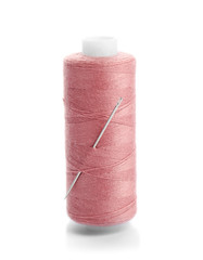 Pink thread and needle on white background