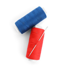 Colorful threads and needle on white background