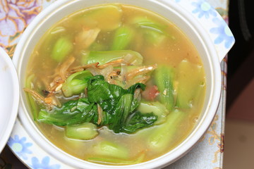 Chinese or Asian cuisine : Soup of baby bok choy or pok choi, green Chinese cabbage on table. Health lifestyle, diet concept. Selective focus