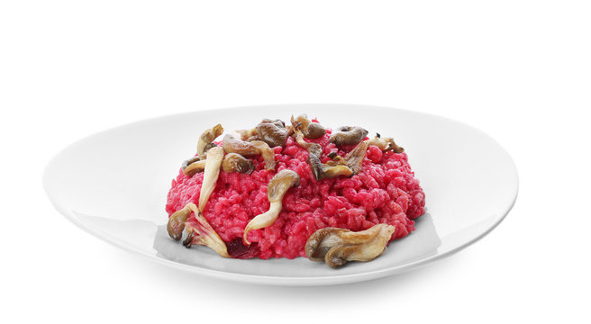 Plate with tasty beetroot risotto with mushrooms on white background