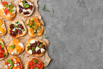 Tasty bruschettas with tomatoes on table, top view