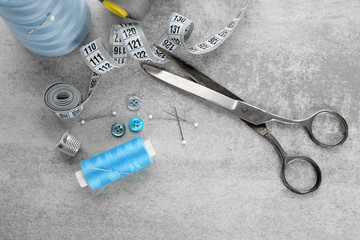 Sewing accessories and thread on table, top view