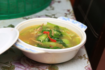 Chinese or Asian cuisine : Soup of baby bok choy or pok choi, green Chinese cabbage on table. Health lifestyle, diet concept. Selective focus