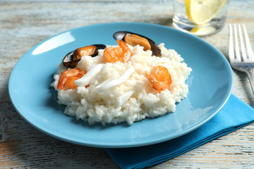 Plate with tasty seafood risotto on table