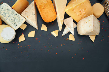 Variety of cheese on dark background