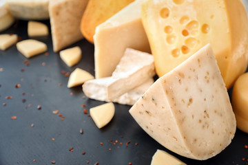 Variety of cheese on dark background