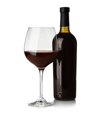 Bottle and glass with red wine on light background