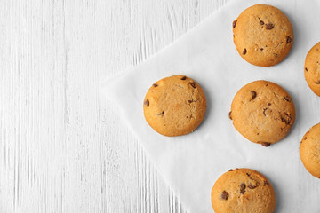 Delicious oatmeal cookies with chocolate chips on wooden table