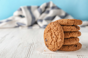 Delicious oatmeal cookies with chocolate chips on wooden table