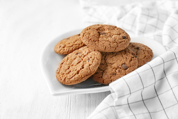 Delicious oatmeal cookies with chocolate chips on plate