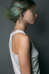 Naklejka premium Gentle cute young woman. Studio portrait. Side view.
