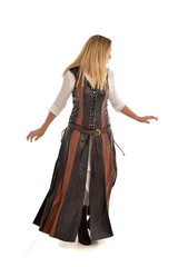 Fototapeta premium full length portrait of girl wearing brown fantasy costume, standing pose with back to the camera on white studio background. 