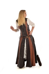 Fototapeta premium full length portrait of girl wearing brown fantasy costume, standing pose with back to the camera on white studio background. 