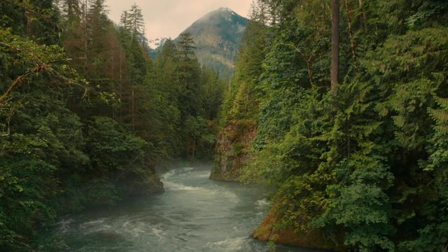 River flowing through landscape with mountain