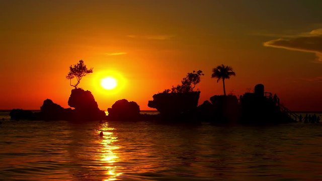 Swimmer Silhouette & Sunset Over Boracay Rock; White Beach Afternoon; Boracay Island, Philippines
