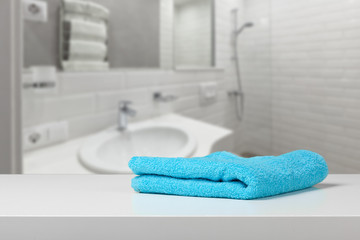 Fototapeta na wymiar Bright colored towel on a shelf in a bathroom