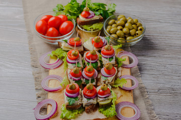 caddies with herring,sandwiches with herring,canapé with herring.