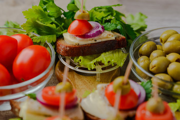 caddies with herring,sandwiches with herring,canapé with herring.