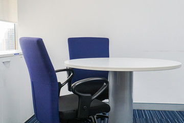 close up modern chairs and round table for meeting in office