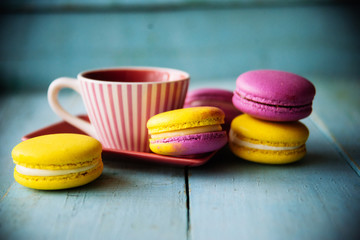 Gentle colorful macaroons on color wooden background