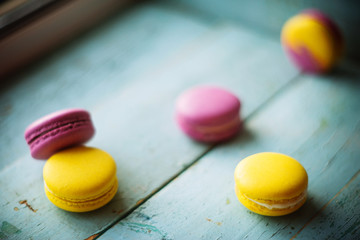 Group of pastel color macaroons on blue textured shabby chic background, with room for copy space