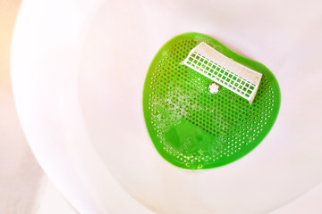 Close up football goal in urinal men toilet