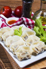 Asian dumplings in bowl, chopsticks, Chinese dumplings for dinner.Chinese dumplings for dinner/lunch. Traditional Asian/Chinese cuisine.