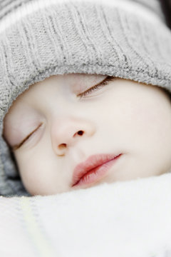 Portrait of little child wearing knit cap sleeping