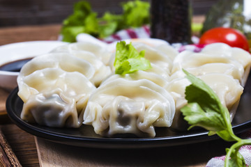 Asian dumplings in bowl, chopsticks, Chinese dumplings for dinner.Chinese dumplings for dinner/lunch. Traditional Asian/Chinese cuisine.
