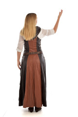 Naklejka premium full length portrait of girl wearing brown fantasy costume, standing pose with back to the camera on white studio background. 