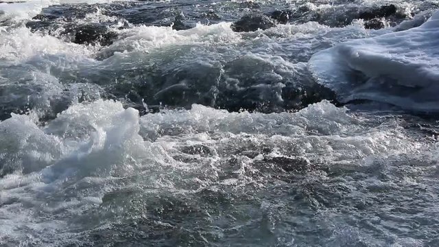 Stormy stream of water in the river in the spring in back lit , Chemal River, Altai, Russia
