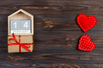 14 February. wood calendar with red heart and gift box on top Valentine's Day card. Copy space