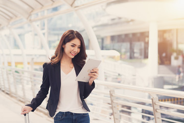 Professional young business woman  reading electronic book on digital tablet for bussiness job at the city in morning. Business woman concept