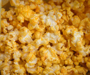 Salted popcorn grains with cheese. Selective focus with shallow depth of field.