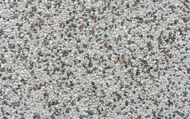 Wall with small stones as texture background.