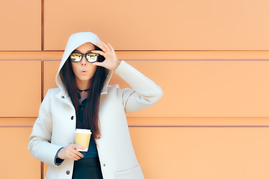 Cool Urban Fashion Girl With Hooded Coat and Coffee
