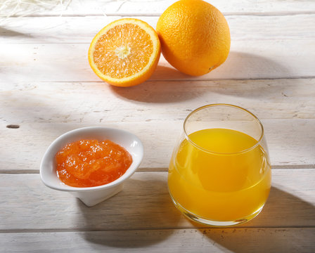 Orange jam and juice in glass. Morning breakfast.