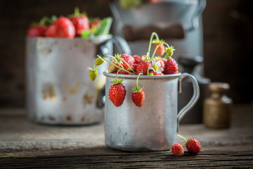 Full of vitamins wild strawberries in the old wooden box