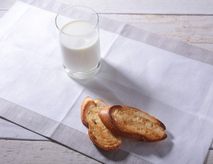 Morning Breakfast set with orange jam on bread toast and milk in glass.