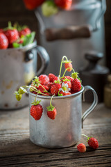Delicious wild strawberries in the old wooden box