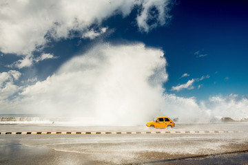 Malecon, Habana, Cuba. Waves splashing a car